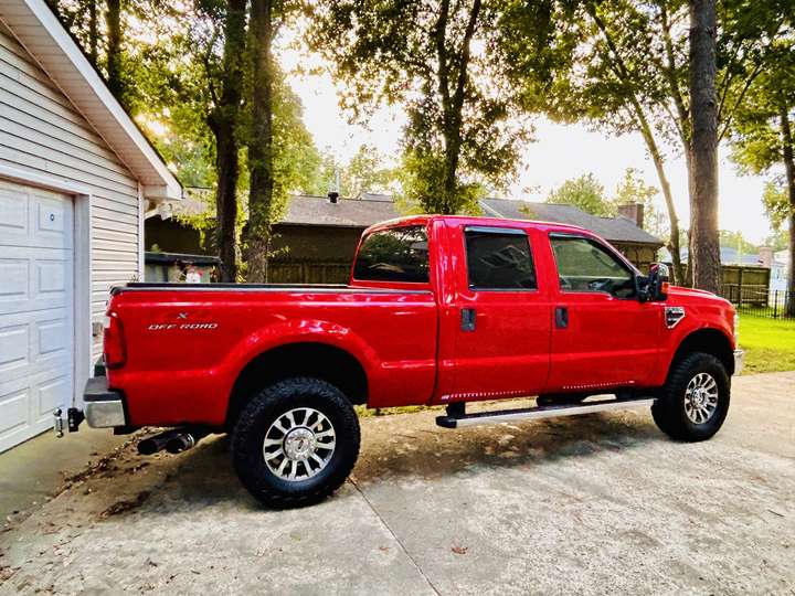 Red Ford work truck parked in a driveway under trees in Myrtle Beach, SC